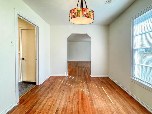 a view of a room with wooden floor and window