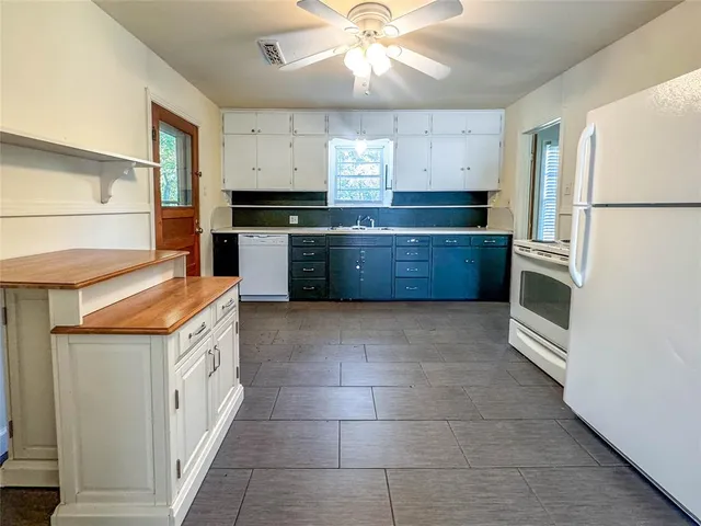 a kitchen with a stove a refrigerator and a sink