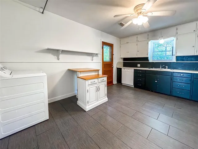 a large kitchen with stainless steel appliances granite countertop a stove and a sink