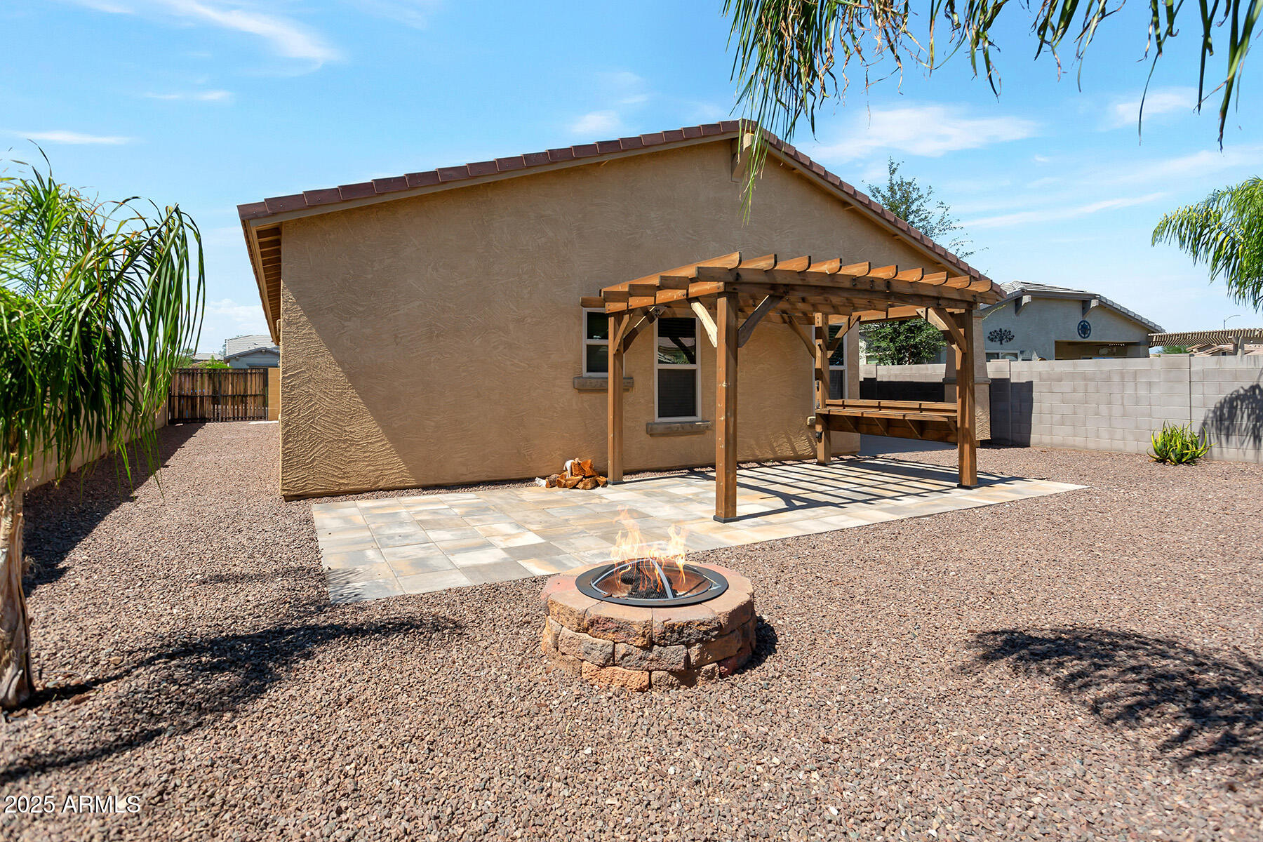 18021 West Tasha Drive Surprise, AZ 85388 - Photo 2 of 16 a backyard of a house with barbeque oven table and chairs
