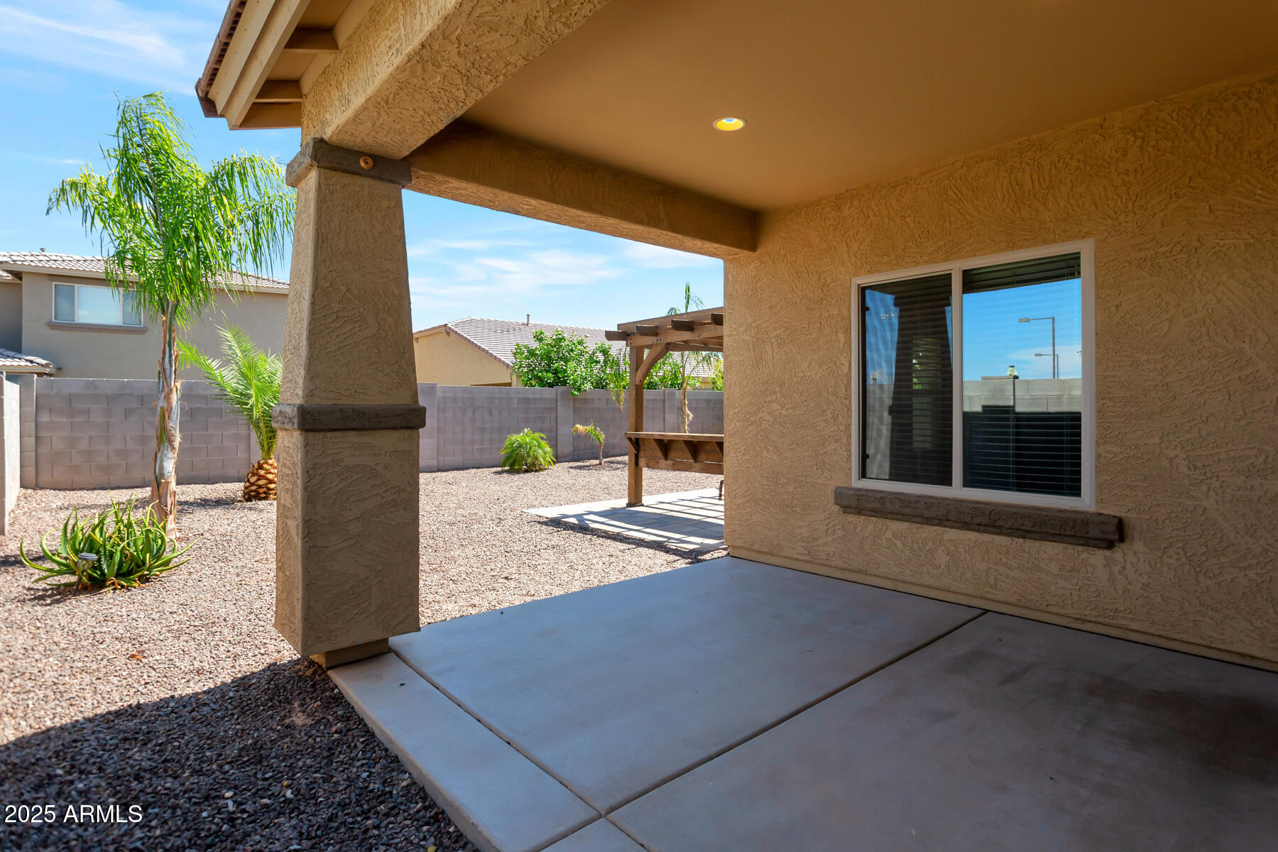 18021 West Tasha Drive Surprise, AZ 85388 - Photo 3 of 16 a view of an entryway with a floor to ceiling window and potted plants