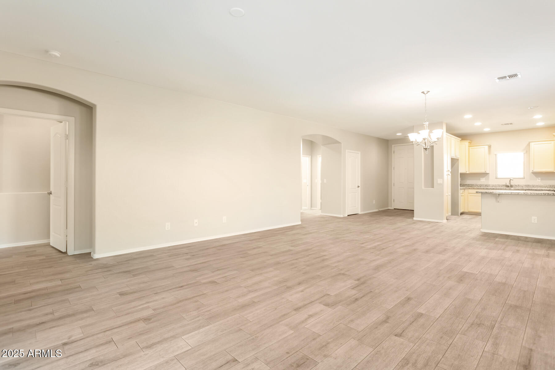 18021 West Tasha Drive Surprise, AZ 85388 - Photo 4 of 16 a view of a kitchen with a sink and a refrigerator
