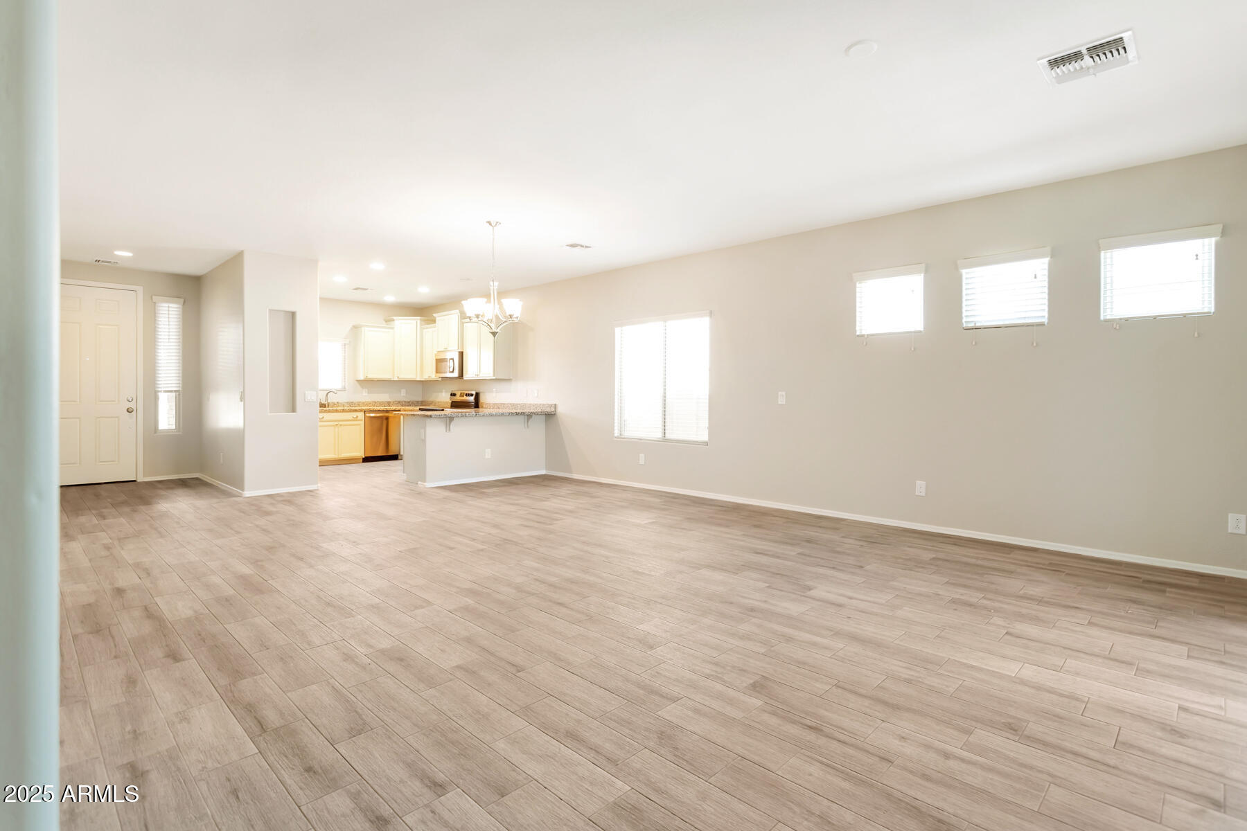 18021 West Tasha Drive Surprise, AZ 85388 - Photo 5 of 16 a view of an empty room with a kitchen