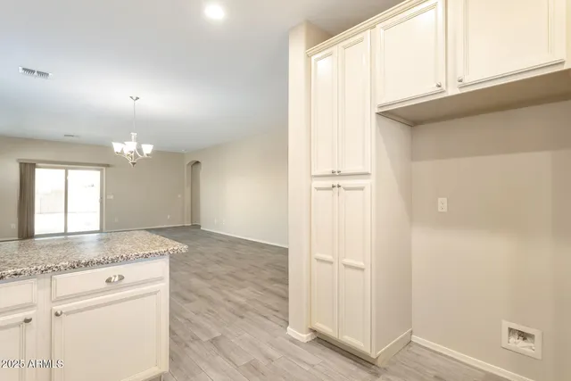 a view of a kitchen cabinets and wooden floor