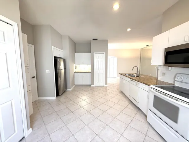 a living room with furniture a window and a flat screen tv