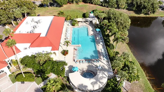 an aerial view of a house with a yard and a fountain