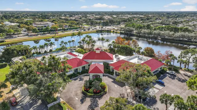 an aerial view of residential houses with outdoor space and lake view