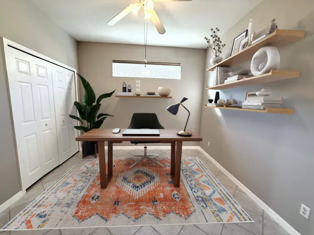 an empty room with chandelier fan