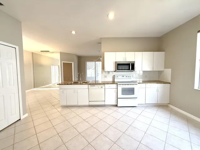 an empty room with closet and windows