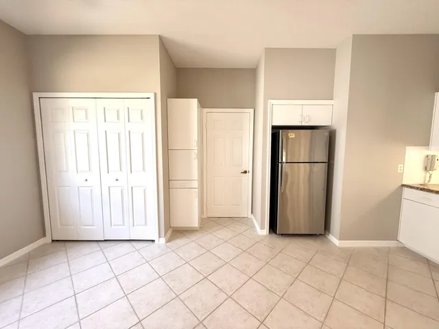 a large white kitchen with a sink and a stove top oven