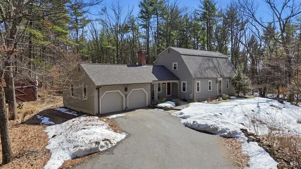 a view of a house with a snow in the yard