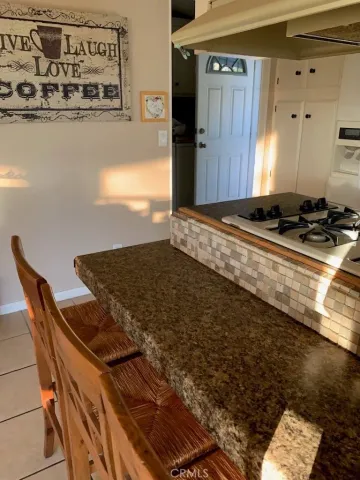 a kitchen with granite countertop a stove and a refrigerator