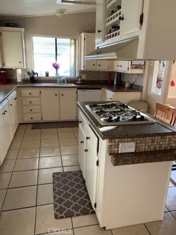 a kitchen with a stove a sink and a refrigerator