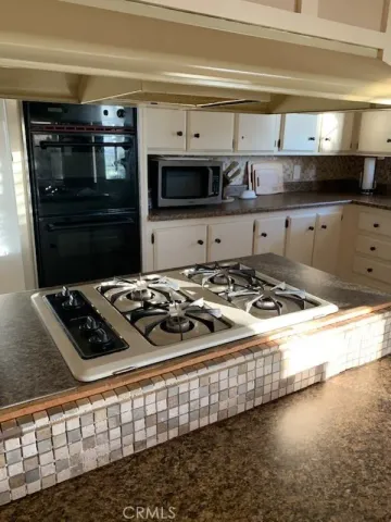 a kitchen with a stove and a microwave
