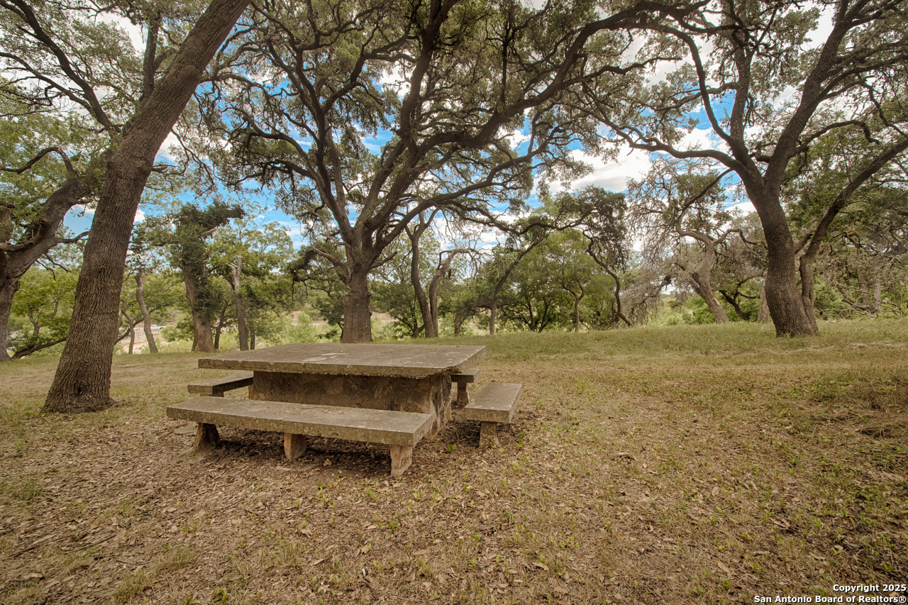 Tbd English Crossing Bandera, TX 78003 - Photo 14 of 18 a backyard of a house with outdoor seating and trees