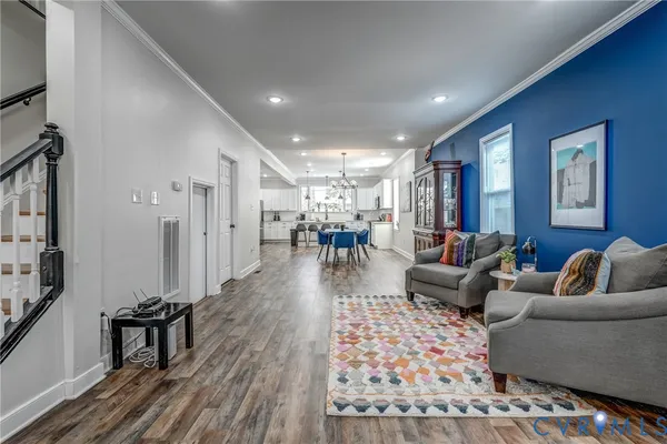 a spacious bedroom with a bed a couch and a flat screen tv