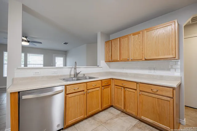 a kitchen with a sink cabinets and window