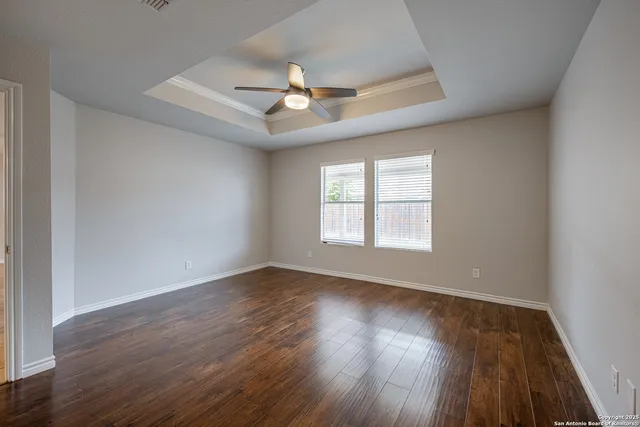 wooden floor in an empty room with a window