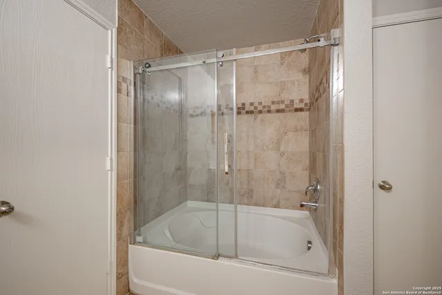 a bathroom with a shower and a bathtub