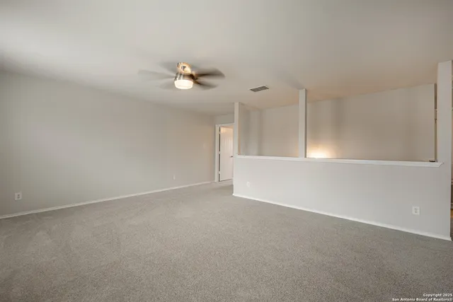 a view of an empty room with a fan