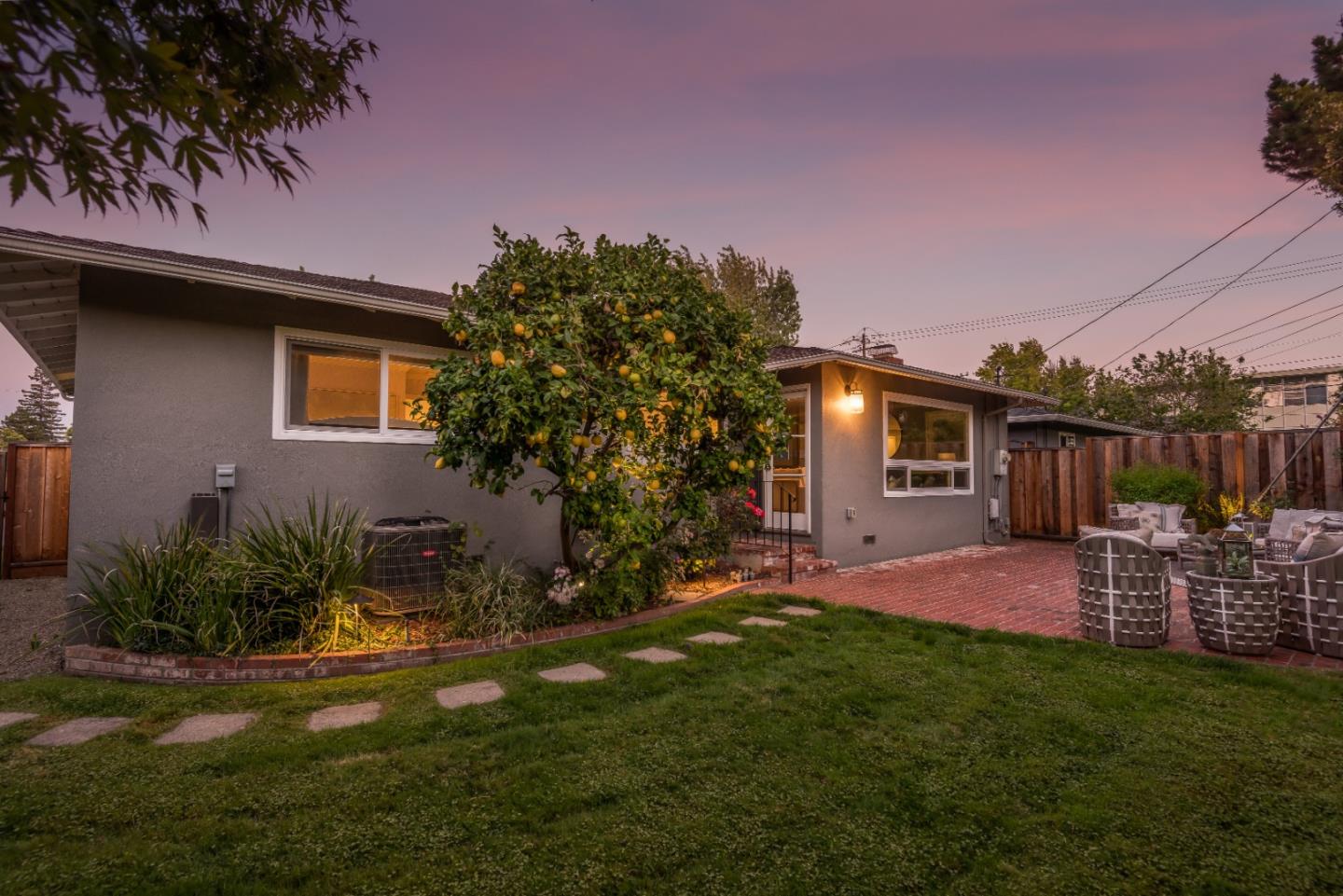 115 Chukker Court San Mateo, CA 94403 - Photo 22 of 23 a patio with table and chairs with plants and wooden fence
