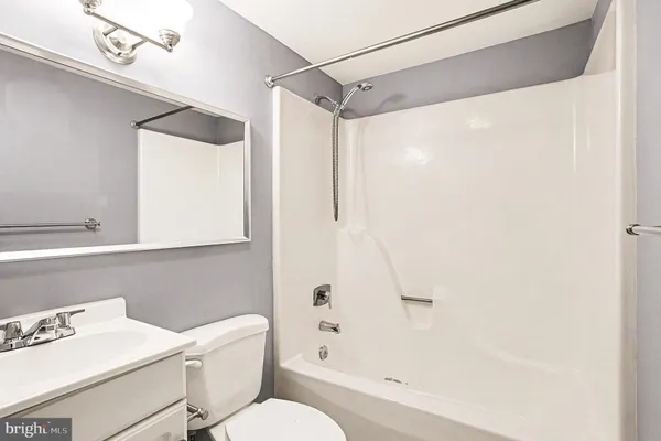 a bathroom with a shower a toilet and a sink