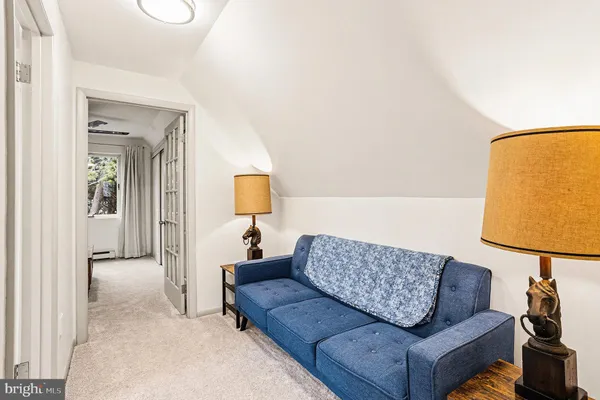 a living room with furniture and a lamp