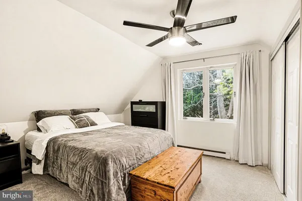 a bedroom with two beds and a window