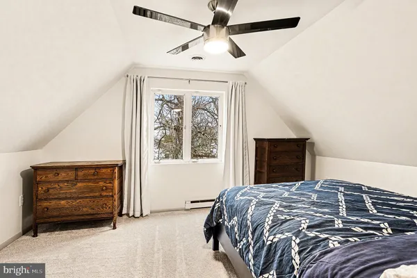 a bedroom with a bed and a ceiling fan