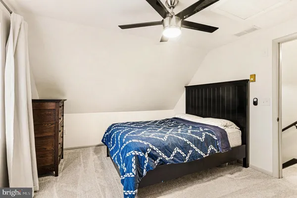 a bedroom with a bed and a wall painting