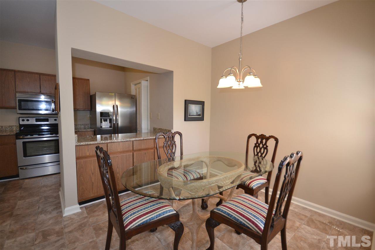 6151 Summer Pointe Place, Unit 103 Raleigh, NC 27606 - Photo 11 of 12 Dining area opens up to kitchen and living room in this great open floor design.