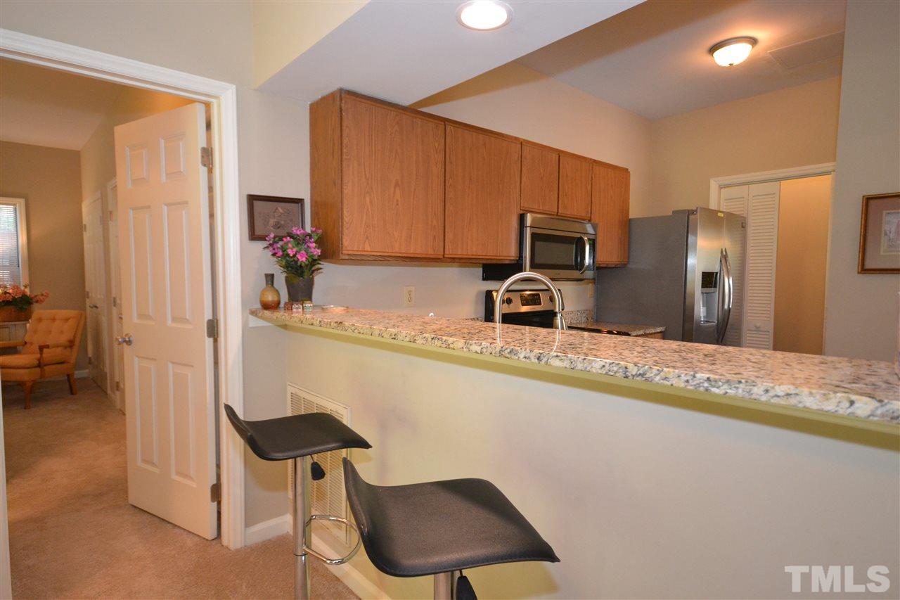 6151 Summer Pointe Place, Unit 103 Raleigh, NC 27606 - Photo 4 of 12 Eat-in bar perfect for breakfast or entertaining.