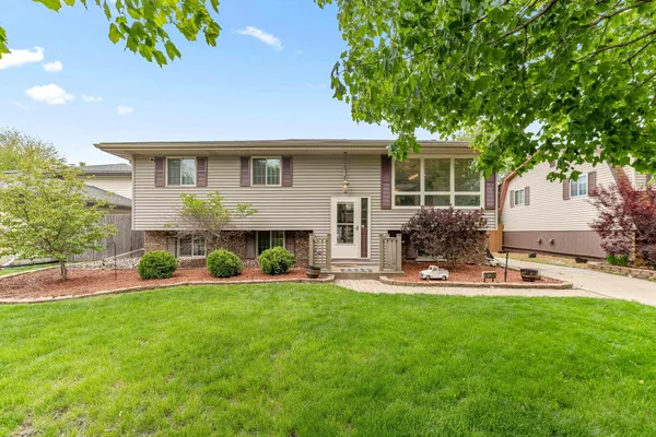 a front view of house with yard and outdoor seating