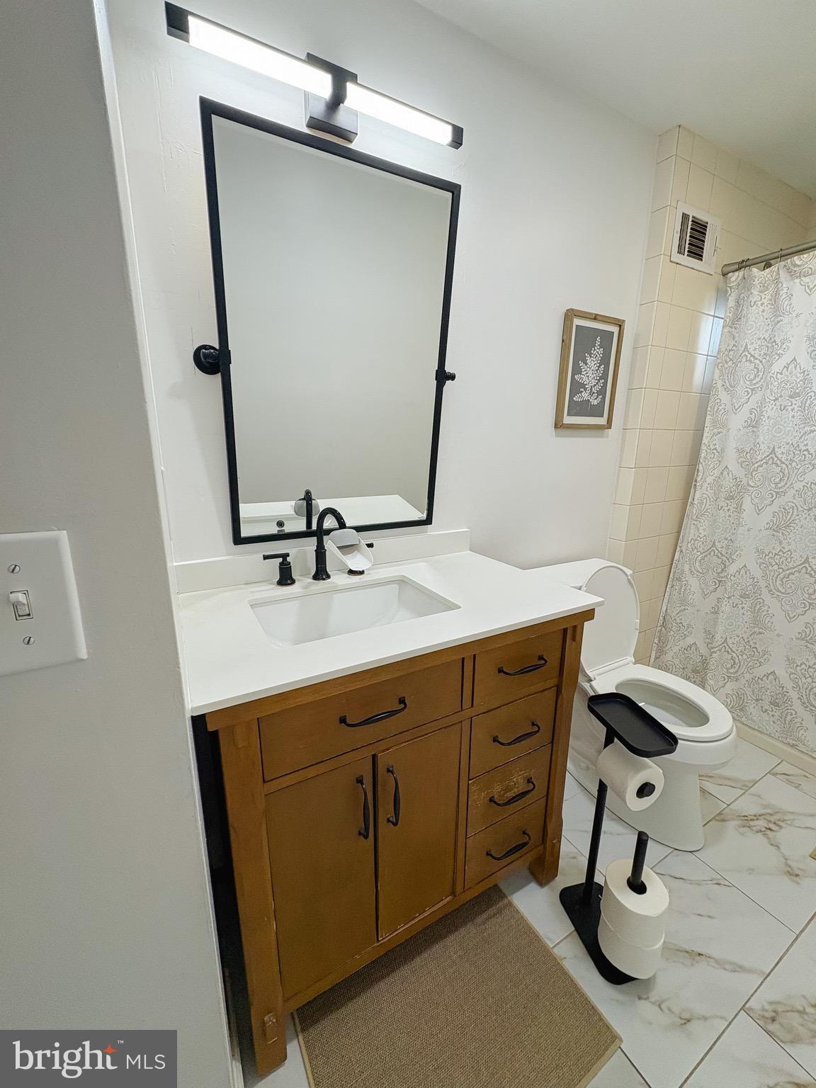 1947 Sand Hill Road Hershey, PA 17033 - Photo 7 of 16 a bathroom with a sink mirror and toilet