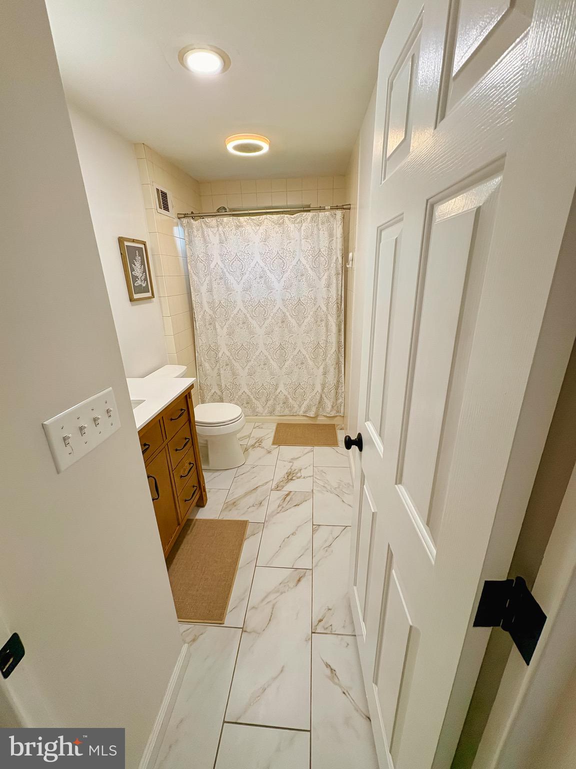 1947 Sand Hill Road Hershey, PA 17033 - Photo 9 of 16 a bath room with a toilet a sink and a mirror