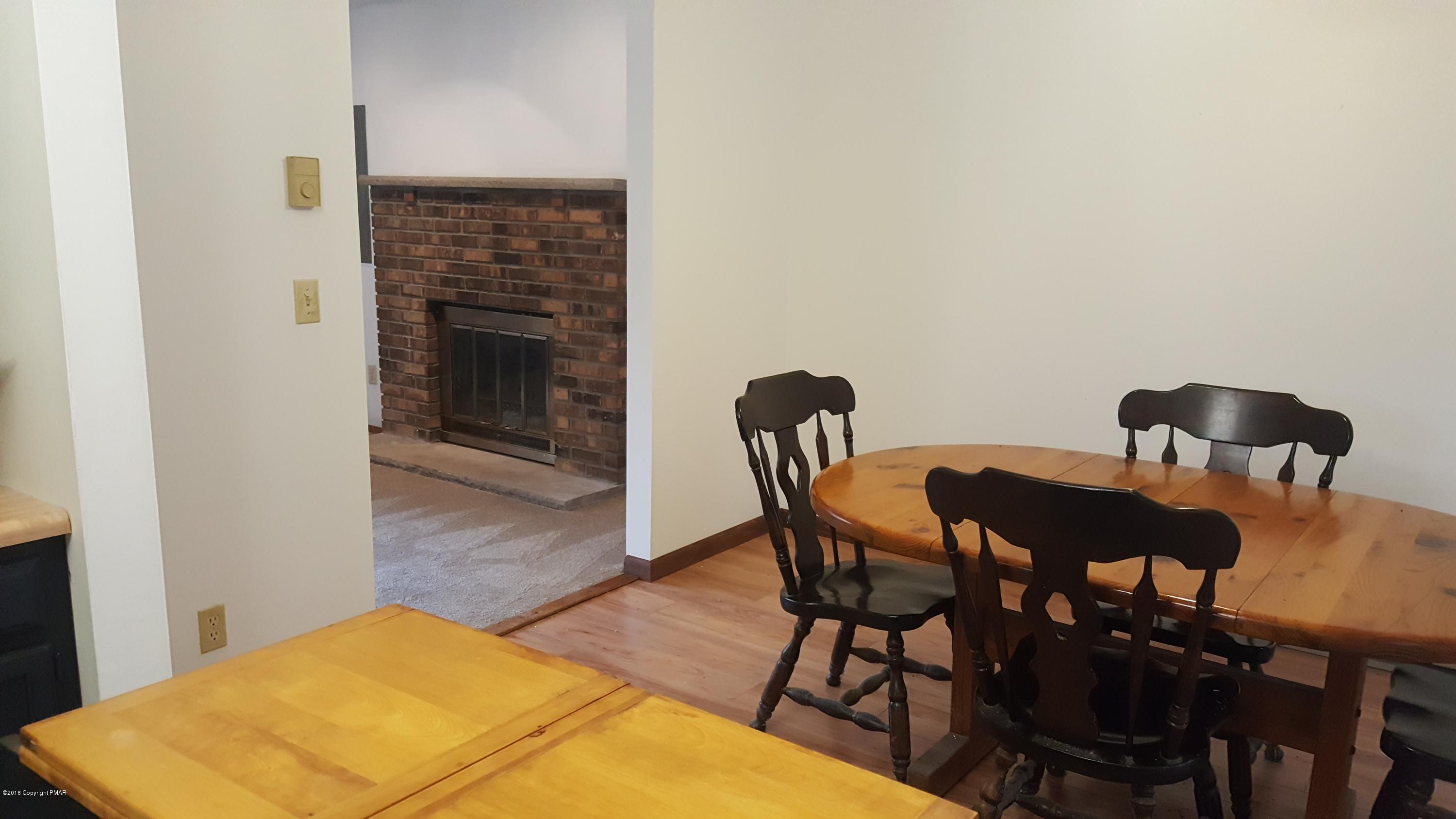 114 Weasel Road Dingmans Ferry, PA 18328 - Photo 11 of 51 a view of a dining room with furniture and wooden floor