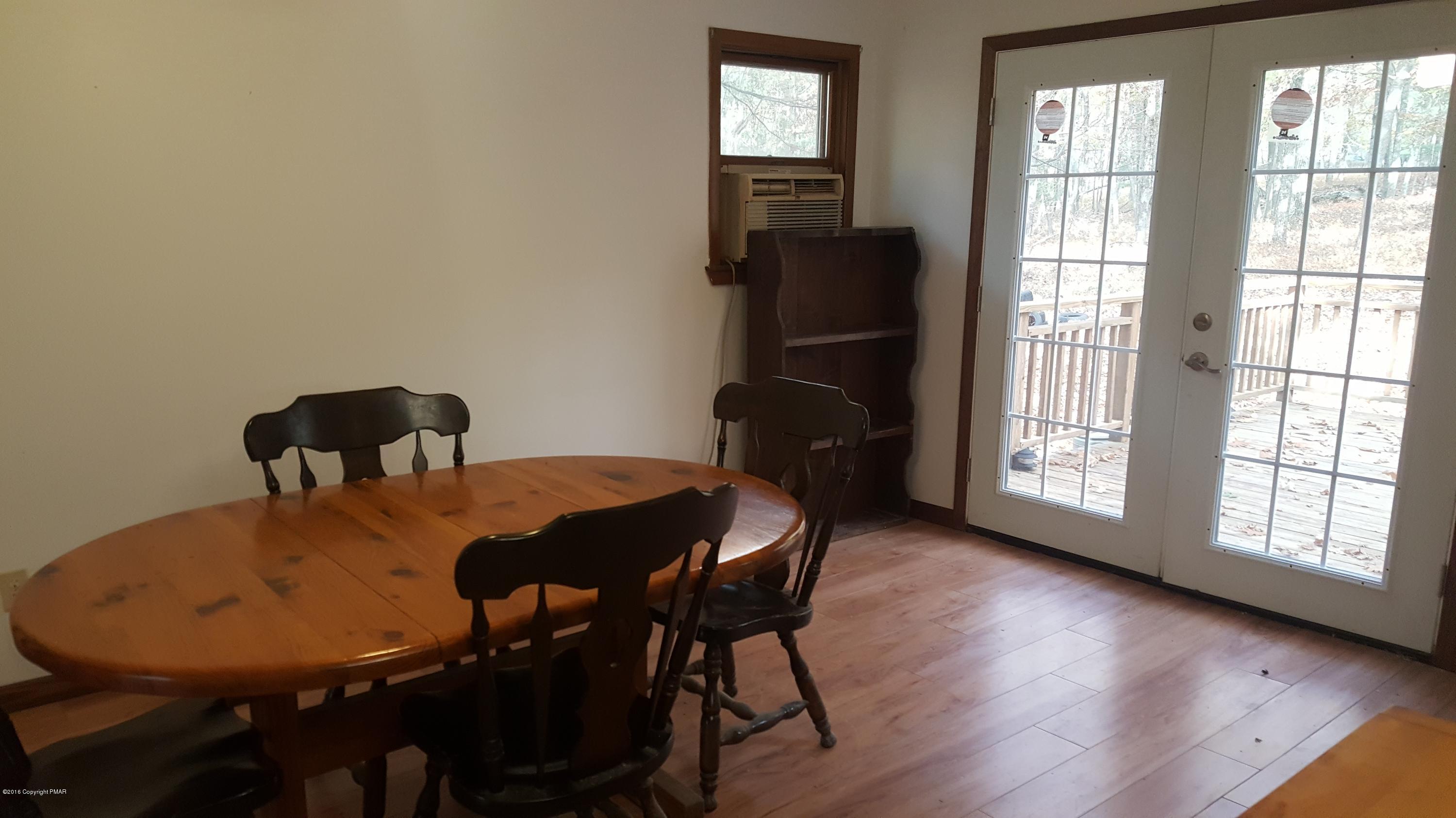114 Weasel Road Dingmans Ferry, PA 18328 - Photo 14 of 51 a view of a dining room with furniture and wooden floor