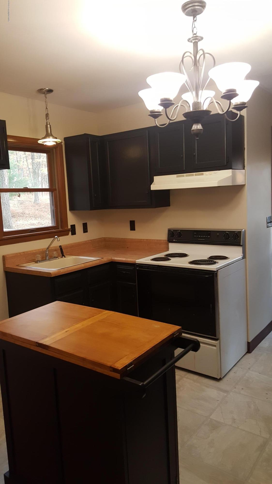 114 Weasel Road Dingmans Ferry, PA 18328 - Photo 20 of 51 a kitchen with a sink and a stove