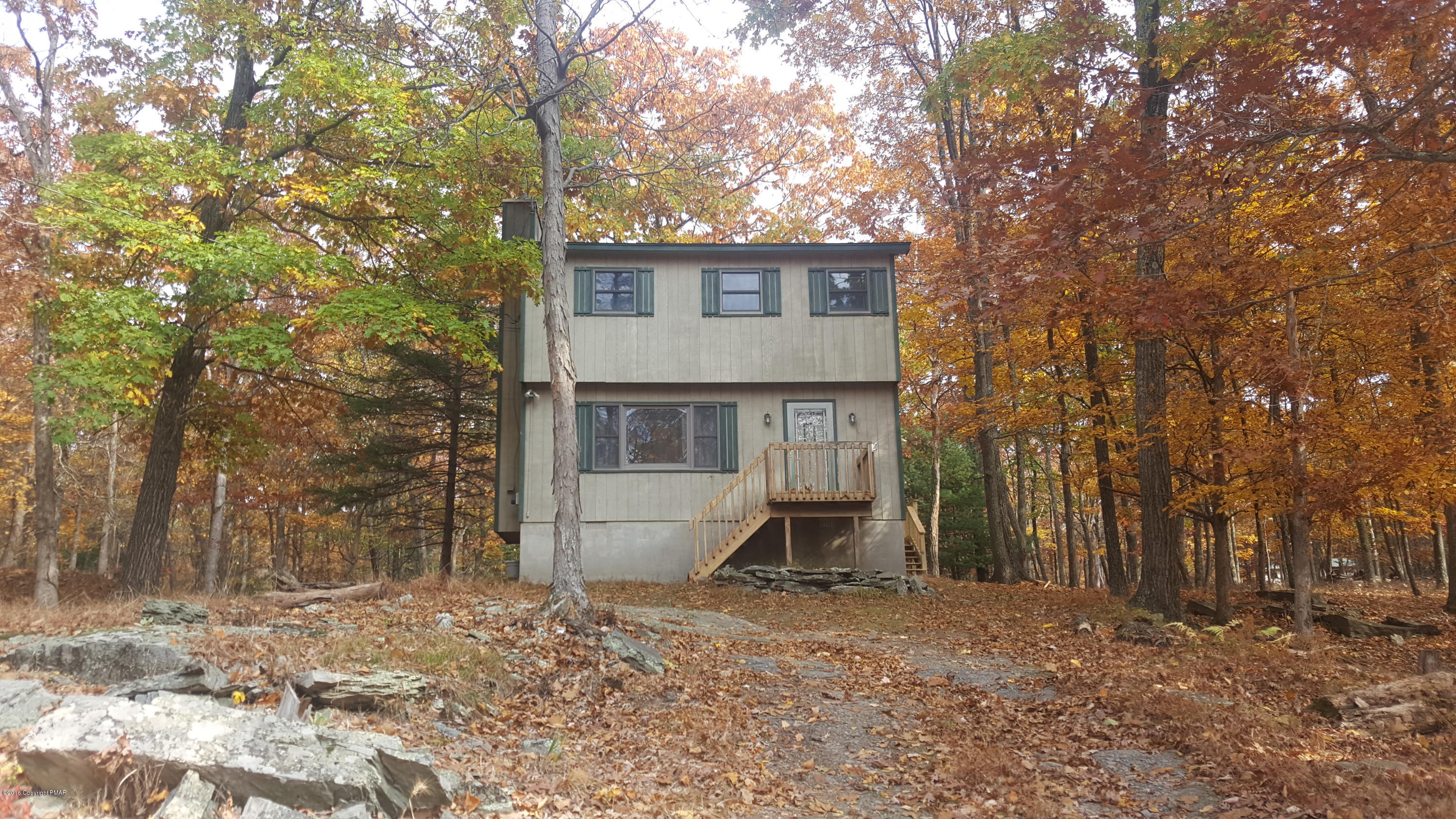 114 Weasel Road Dingmans Ferry, PA 18328 - Photo 2 of 51 a front view of a house with a yard and garage