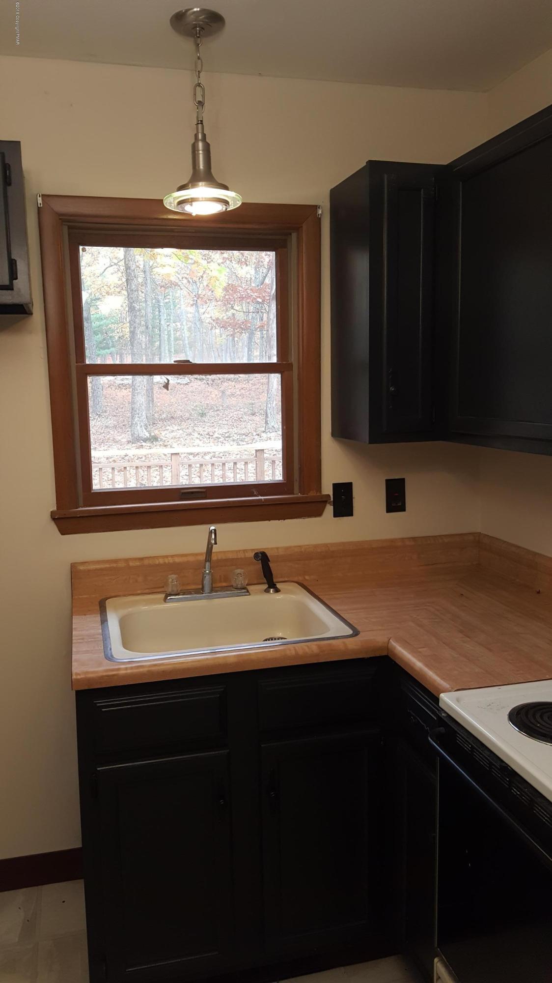114 Weasel Road Dingmans Ferry, PA 18328 - Photo 22 of 51 a kitchen with a sink and a window