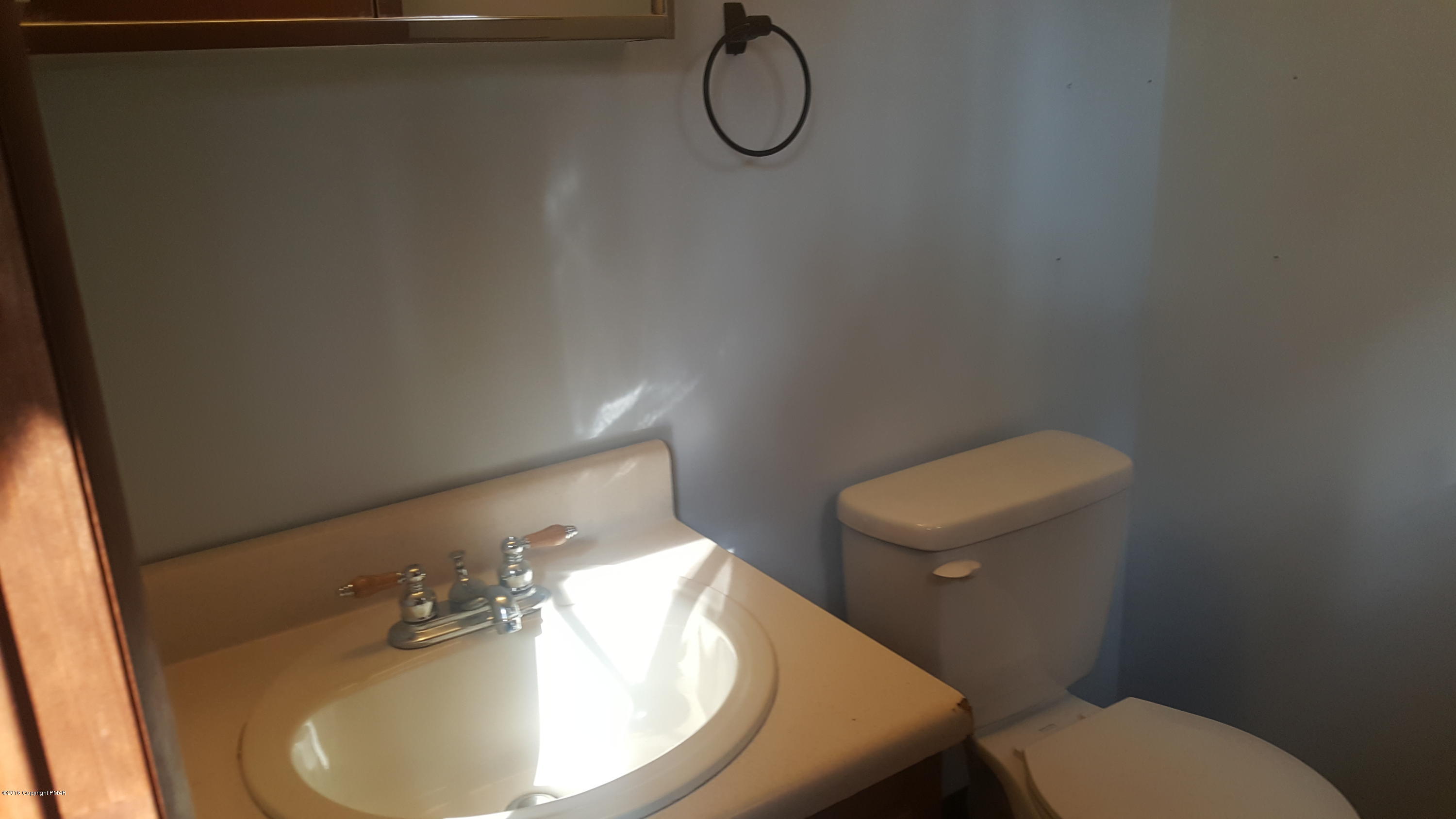 114 Weasel Road Dingmans Ferry, PA 18328 - Photo 24 of 51 a bathroom with a toilet and a sink