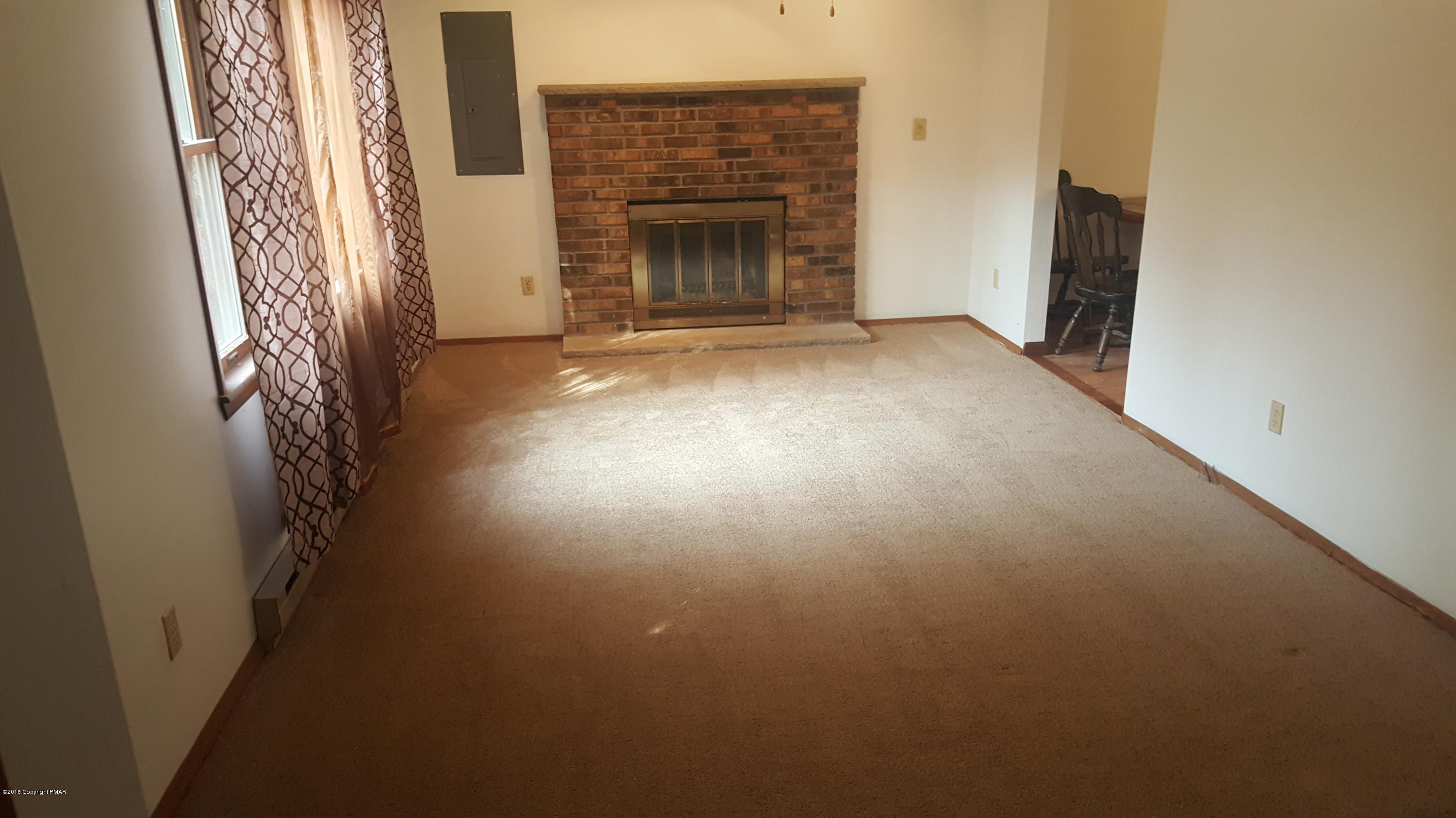 114 Weasel Road Dingmans Ferry, PA 18328 - Photo 3 of 51 a view of a livingroom with an empty space and fire place
