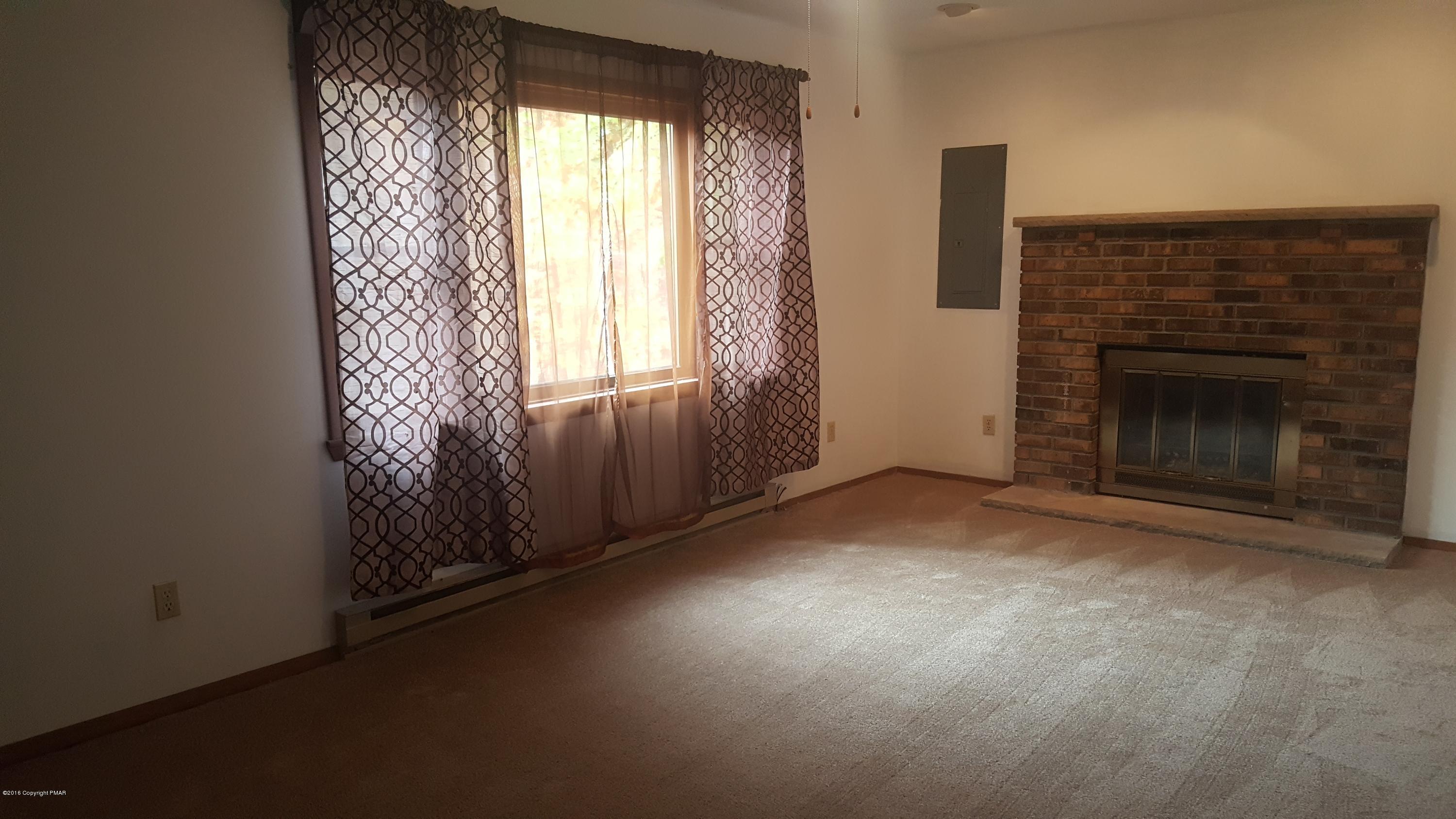 114 Weasel Road Dingmans Ferry, PA 18328 - Photo 6 of 51 an empty room with windows