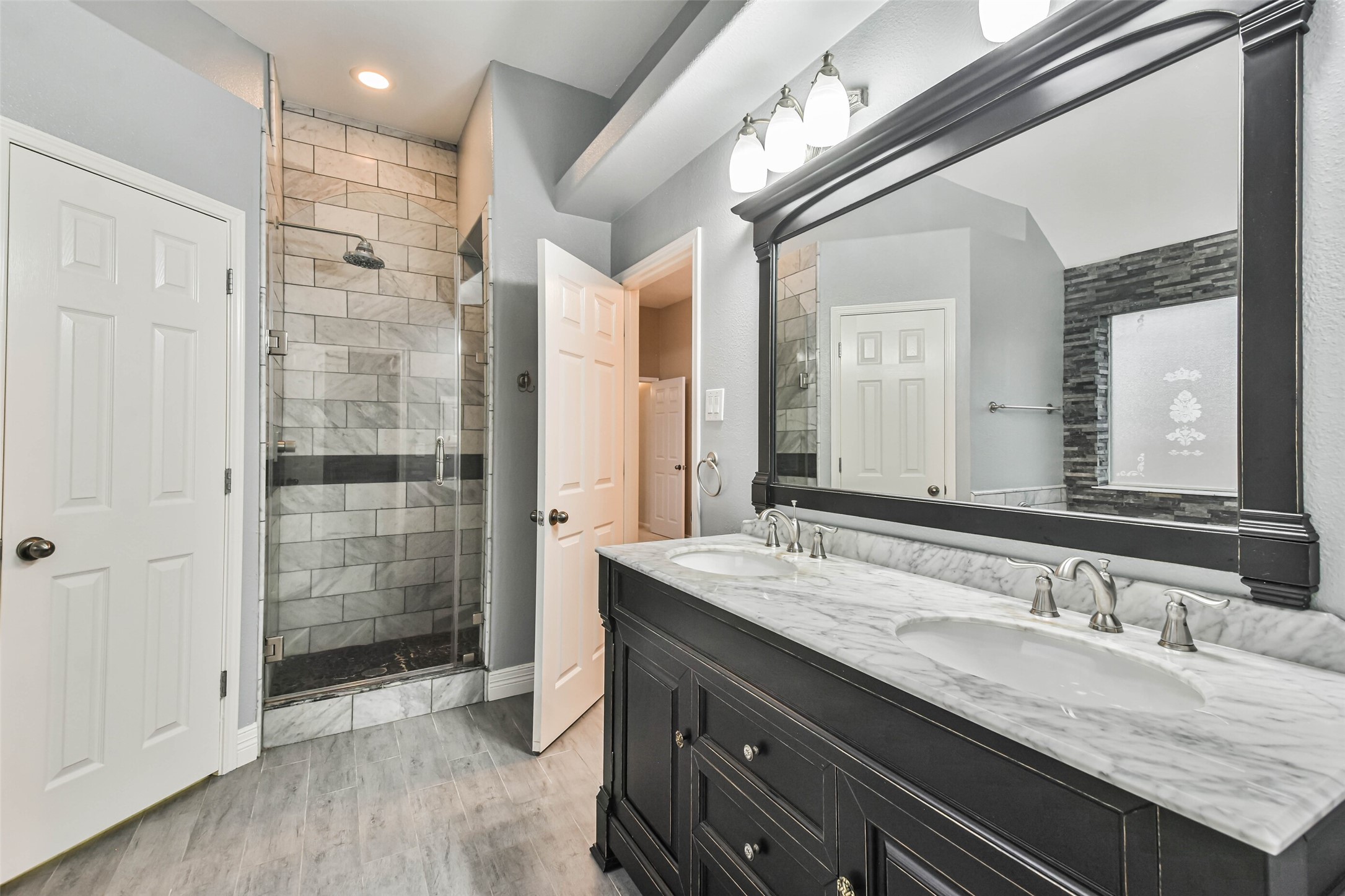 20942 Wind Field Lane Spring, TX 77379 - Photo 28 of 46 a bathroom with a granite countertop sink mirror and double