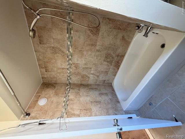 43038 Hanford Road Canton, MI 48187 - Photo 26 of 36 Bathtub and shower combination featuring neutral-toned tile surround with a decorative mosaic accent band