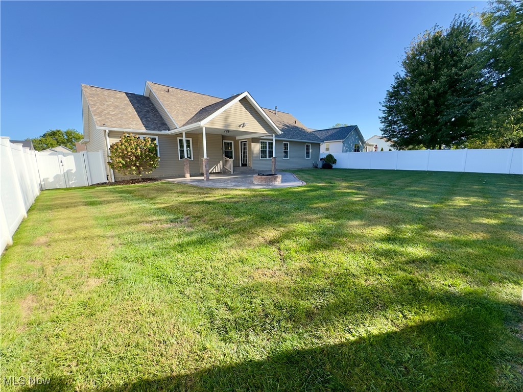 6014 Wentworth Road Southwest Canton, OH 44706 - Photo 19 of 22 Rear view of house featuring a fenced backyard, a patio, and a shingled roof