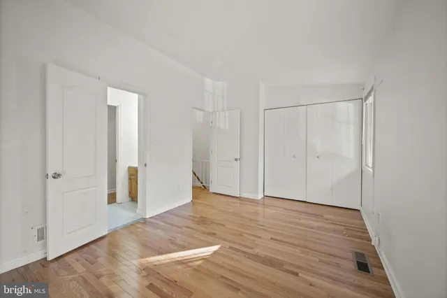 a view of an empty room and wooden floor