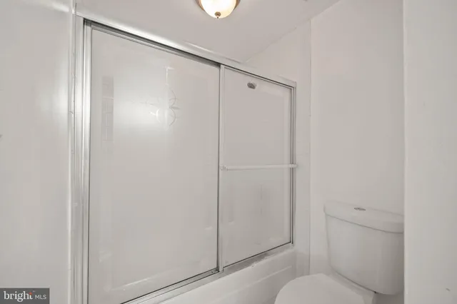 a bathroom with a shower and a toilet