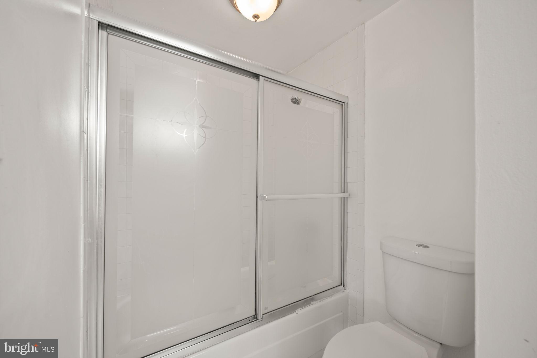 5451 Endicott Lane Columbia, MD 21044 - Photo 18 of 28 a bathroom with a shower and a toilet