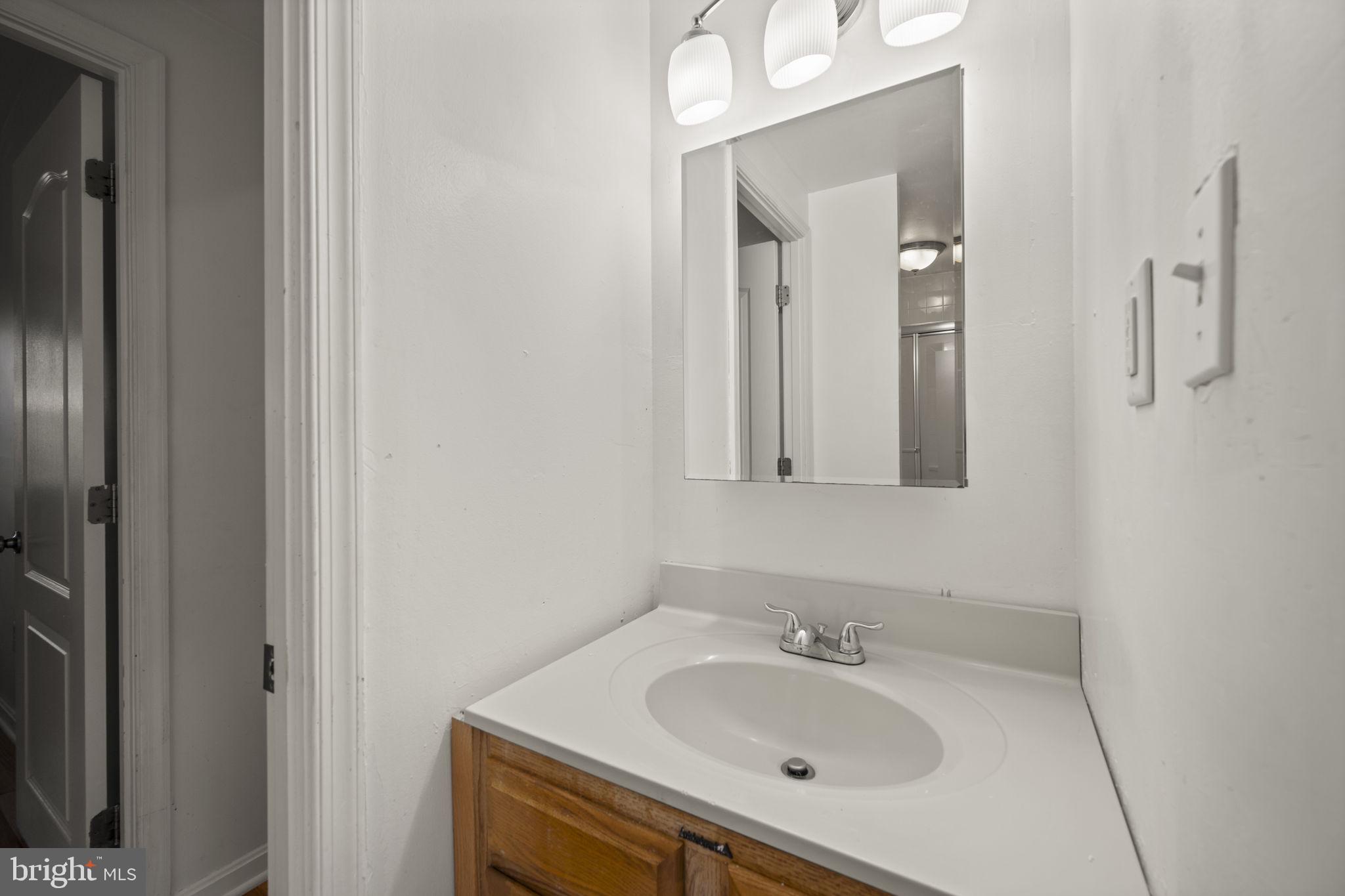 5451 Endicott Lane Columbia, MD 21044 - Photo 19 of 28 a bathroom with a sink and a mirror